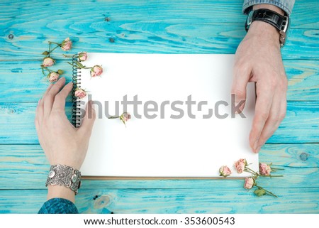 Love Letter and flowers. Couple affection romance. Blue wood background. Top view. Intriguing Secret Story