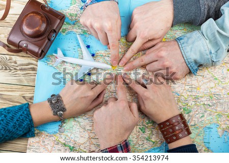 six cool friends are planning euro trip. The company of six gay friends are planning trip to France. Together point to Paris. The unanimous decision. Happy tourists. Top view. Buy plane tickets soon!