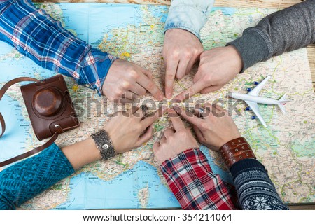 Organization of group travel. Desk Travel Agency. six Friends are going to visit Bavaria Germany Munich. Top view. Map and camera.