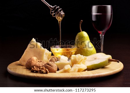 parmesan cheese, pears, honey, walnuts and wineglass