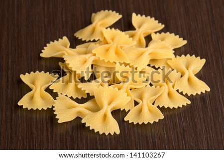 pile of bow tie pasta on wooden background