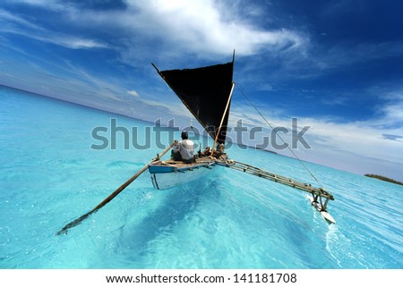 rowing boat sailing in a tropical lagoon