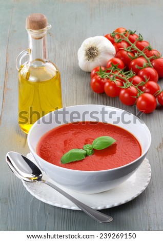tomato soup and ingredients on wooden table