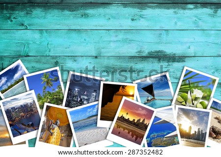 heap of travel photos on azure wood background