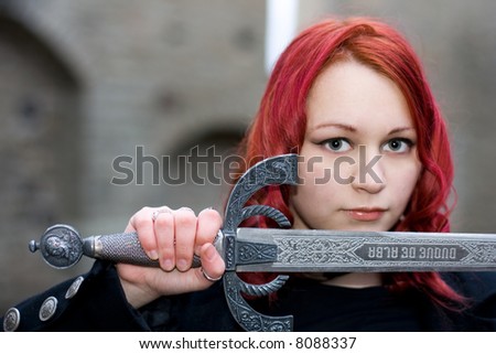 Redhead gothic girl with a ancient sword