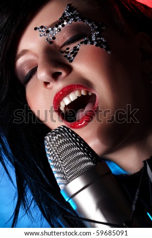 Closeup portrait of singing woman with closed eyes