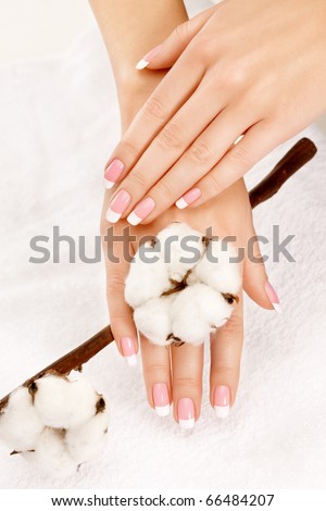 Nicely manicured hands with cotton crop over a towel