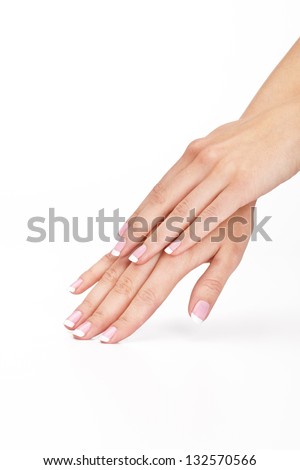 Female hand with french manicure touching seamless background