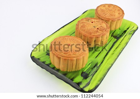 moon cakes on a plate of green glass