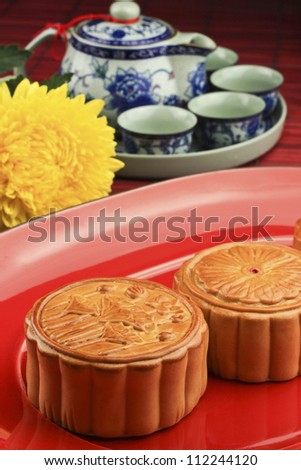 moon cakes on a plate with a tea set