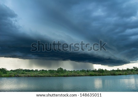 landscape of sunset with dark clouds above a lake