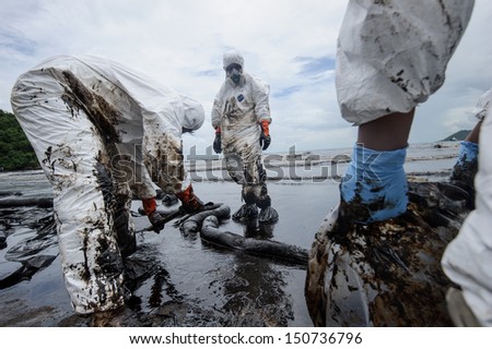 RAYONG, THAILAND - JULY 31: cleaning operations of crude oil due to spill accident on Ao Prao Beach in Samet island on July 31, 2013 in Rayong,Thailand