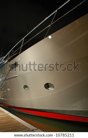 Side view of Gray luxury yacht at night with portholes