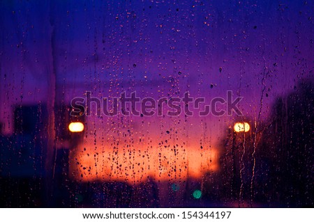 Drops of a rain on a window pane. Autumn raindrops