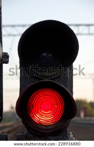 Traffic light shows red signal on railway. Red light