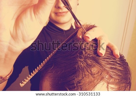 Man having a haircut with a hair clippers over a white backgroun retro