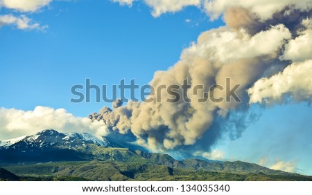 Erupting volcano emits a large amount of smoke