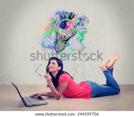 Beautiful Caucasian woman smiles thinking in front of his laptop. Concept of the Internet. Woman lying full length isolated on white background