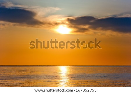 sunset in orange tones over a calm sea