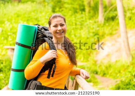 charming brunette in a hike with a backpack