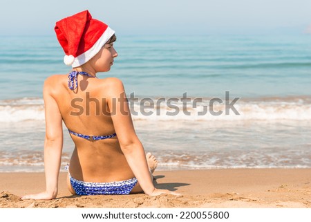 beautiful young woman celebrating the new year on the beach