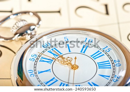 silver watch with gold hands and a calendar closeup