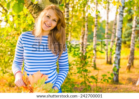 happy expectant mother walks in autumn park