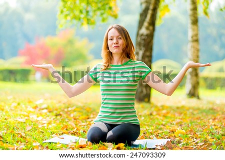 woman in autumn park holding something on the palms