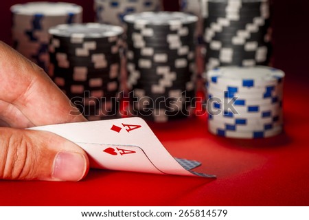 poker game. man\'s hand with a pair of aces