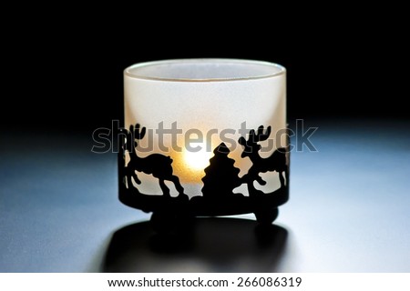 glass candle holder with a burning candle