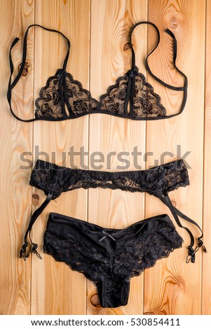 Women\'s set seductive lingerie close-up on the wooden floor