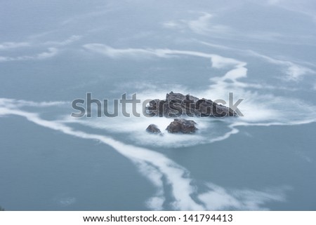 ocean wave washes over the rocky shore (Portugal, Atlantic Ocean, Cape Roca)