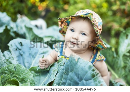 Happy little child in cabbage