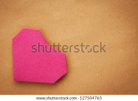 Hand made paper heart on kraft paper as background. Greeting card. Free space for text