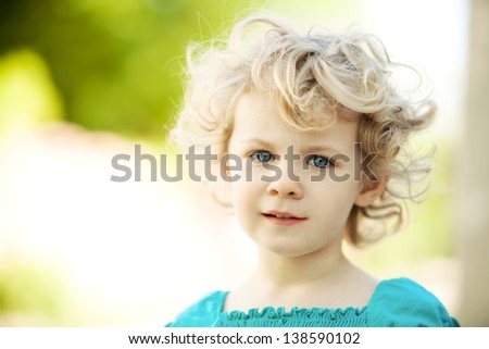 Adorable little girl taken closeup outdoors in summer