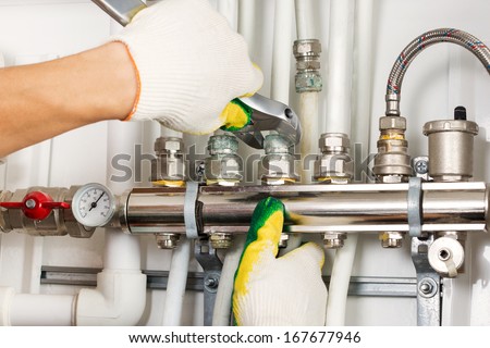 Worker hands fixing heating system
