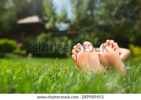 Little feet on the grass, close up photo