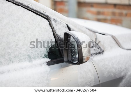 Closeup of a car covered in snow and ice
