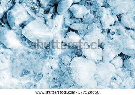 Ice background. Frozen white stones under thick ice texture