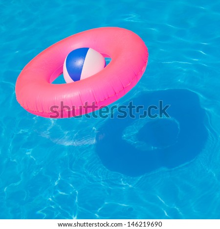 Pink pool float, pool ring in cool blue refreshing blue pool