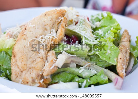 Healthy salad with chicken and vegetables in bowl