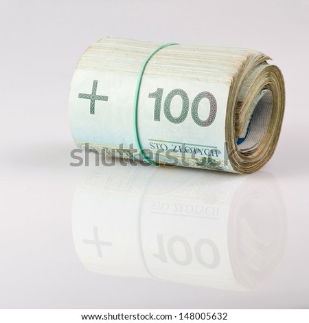roll of one undred polish zloty bills tied in burlap string isolated on a white background