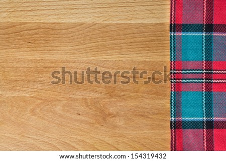 Background with tablecloth over wooden cutting board