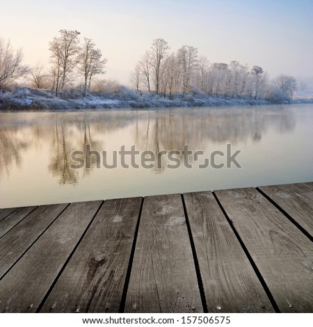 Winter sunrise and empty wooden deck table. Ready for product montage display.