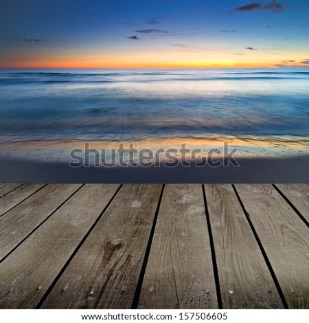Sunset and empty wooden deck table. Ready for product montage display.