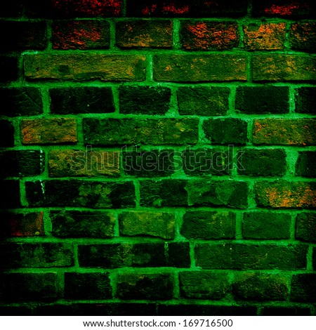 green brick wall getting older from the bottom