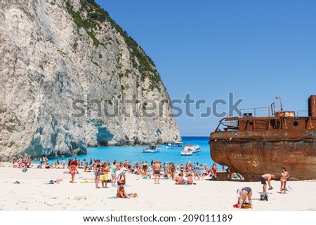 Zakynthos, Greece - June 01: Tourists at the Navagio Beach in Zakynthos, Greece on June 01, 2014. Navagio Beach is most popular attraction among tourists visiting the island of Zakynthos.