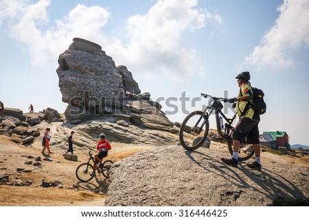 Bucegi Mountains, Romania July 09, 2015: Unidentified group of bikers climbs the hill in Bucegi Mountains in Romania on July 09, 2015.