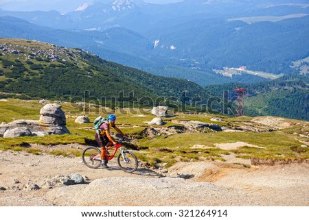 Bucegi Mountains, Romania July 09, 2015: Unidentified biker climbs the hill in Bucegi Mountains in Romania on July 09, 2015.
