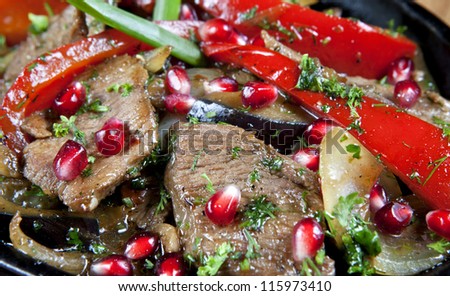 Closeup: Beef Stew in a slow-cooker, ready to serve. cooked with pomegranate and herbs (onion, parsley and dill)